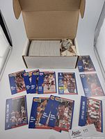 Overview of white storage box containing stacked 1991-92 Fleer cards and loose subset cards laid out in front