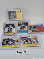 Photo showing all 6 Wayne Gretzky hockey trading cards together in plastic sleeves, including scoring leaders and assist leaders cards from 1979-80.