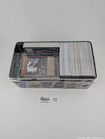 Top view of a metal container filled with Yu-Gi-Oh! cards stored upright showing card backs