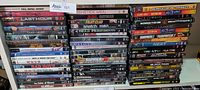 Stack of DVDs including Full Metal Jacket and other titles from the lot, showing mostly action and some classic films.