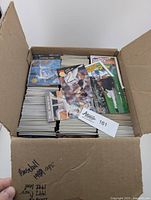 Box of stacked baseball cards from 1988, 1991, and early 1990s, with many cards loosely on top.