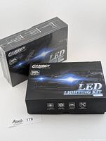 Two FAHREN LED Lighting Kits boxes side by side, one sealed in plastic, one not sealed.
