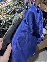 Close-up of inside tag and sleeve of blue Air Jordan Wings Nike pullover showing fabric and detailing.