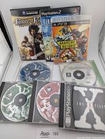 All games and discs shown together including Nintendo GameCube, PS2, PS3, PS1 titles and additional discs.