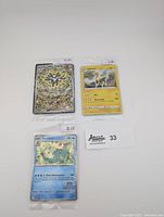 Three sealed Pokémon promo cards: Magneton card with detailed holographic electric design priced $15, Boltund card with basic art at $5, and Feraligatr card from the Illustration Contest priced $20.