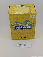 Smirking SpongeBob YouTooz vinyl figure box with yellow geometric pattern and SpongeBob graphics, sealed, with price sticker $40.