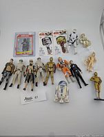 Overview photo showing all items in the lot including figures, cards, and keys