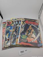 Front view of all 8 comics, stacked with Werewolf by Night #26 visible on top.