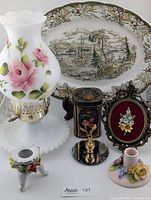 Full view of vintage milk glass hobnail hurricane lamp, Ridgeway Heritage platter, floral bone china candle holders, mini framed porcelain floral inset, and small floral trinket pieces on display.