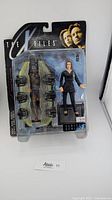 Original sealed blister packaging of McFarlane X-Files Dana Scully Series 1 Fight the Future figure, showing figure, alien accessory, and base stand.