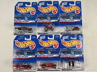 Front view of six sealed Hot Wheels 1998 First Edition series cars in original blue packaging showing the Hot Wheels logo and individual car models.