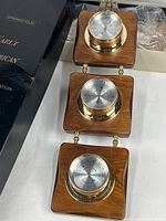 Weather station trio with three brass and wood mounted dials in original box