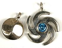 Two sterling silver pendants shown from above on white background, highlighting shapes and finishes.