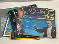 Six vintage vinyl albums stacked, showing front cover of '90 Minutes with Arthur Fiedler and the Boston Pops' featuring conductor Arthur Fiedler in tuxedo on blue background.