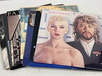 Stack of 8 vinyl record albums showing partial covers for Eurythmics, Linda Ronstadt, Pat Benatar, Barbara Streisand