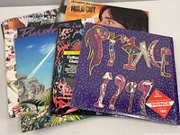 12 vintage vinyl records stacked with visible cover art for Prince 1999, Culture Club, and Jackson Browne.