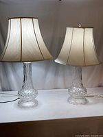 Two crystal table lamps with shades side by side