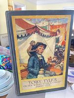 Front cover of Toby Tyler book showing illustrated circus scene