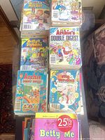Stacks of various Archie paperback comics on table