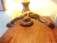 Full view of wooden boomerang with etched designs