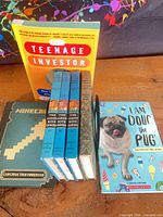 Front view of all eight books upright on table