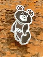 Front view of Misha bear enamel pin showing design and colors