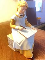 Front view of Amy March figurine holding sketchbook
