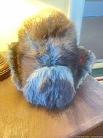 Front view of beaver fur hat with ear flaps up