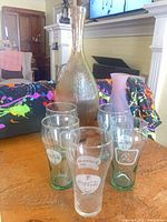 All seven items grouped: tall vase, lavender vase, five Coca-Cola glasses