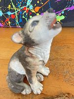 Front angled view of wolf pup figurine showing coloration and pose