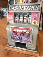 Front view of replica slot machine showing marquee, reels and payout tray