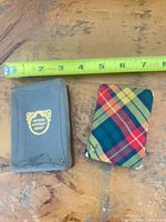 Both miniature books beside ruler showing approximately 3 in. height