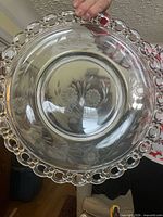 Overview of clear glass platter showing beaded rim and etched floral design
