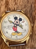 Front view of Lorus Melody Alarm watch showing Mickey Mouse dial and gold-tone case