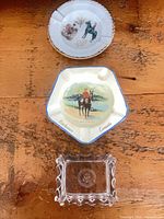 Three ashtrays: two ceramic RCMP pieces and one glass presidential seal ashtray