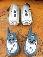 Front view of all four radios showing brands, controls and overall condition