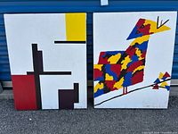 Two pieces of canvas wall art with abstract designs. One is a geometric bird in red, yellow, blue, and black on white background. The other is an abstract geometric composition in red, black, yellow, and white.