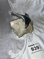 Full view of polished flying goose sculpture mounted on irregular natural rock base, showing overall size and condition.