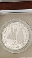 Front of the silver proof coin showing Queen Elizabeth II in coronation robes and a cathedral, with text commemorating the 40th anniversary of the coronation and denomination '50 Vatu'
