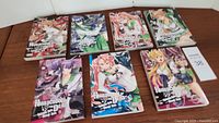 Seven volumes of Highschool of the Dead manga arranged on floor showing front covers, various characters in dynamic poses and colorful anime style art.