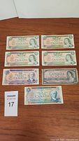 Front side of 7 Canadian banknotes: four $20, two $10, one $5