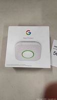 Front view of the Google Nest Protect box showing the device image and Google logo.