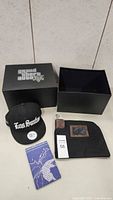 Grand Theft Auto V black storage box with lid, hat, money bag and map on table