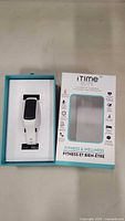 Photo of the iTime Elite Fitness and Wellness Watch inside the open box with white silicone strap and black rectangular screen