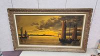 Frontal image of the large horizontal oil painting showing sailboats on calm water at sunset, with ornate gold frame.