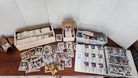 View of multiple boxes with hockey cards and loose cards spread on a table showcasing variety and quantity of cards