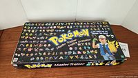 Closed box for Pokemon Master Trainer board game with illustrated Pokemon characters and branding