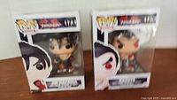 Photo of two boxed Tekken Funko Pop figures, numbers 173 and 175, side by side showing front packaging and figures inside.