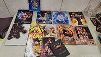 Photo showing the spread of various video game strategy guides and manga guide books on a table.