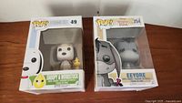 Two boxed Funko Pop vinyl figures: Peanuts 49 Snoopy & Woodstock and Winnie the Pooh 254 Eeyore